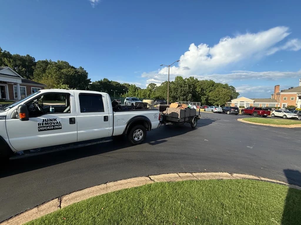 Famous Hauling & Service branded junk removal truck with loaded trailer